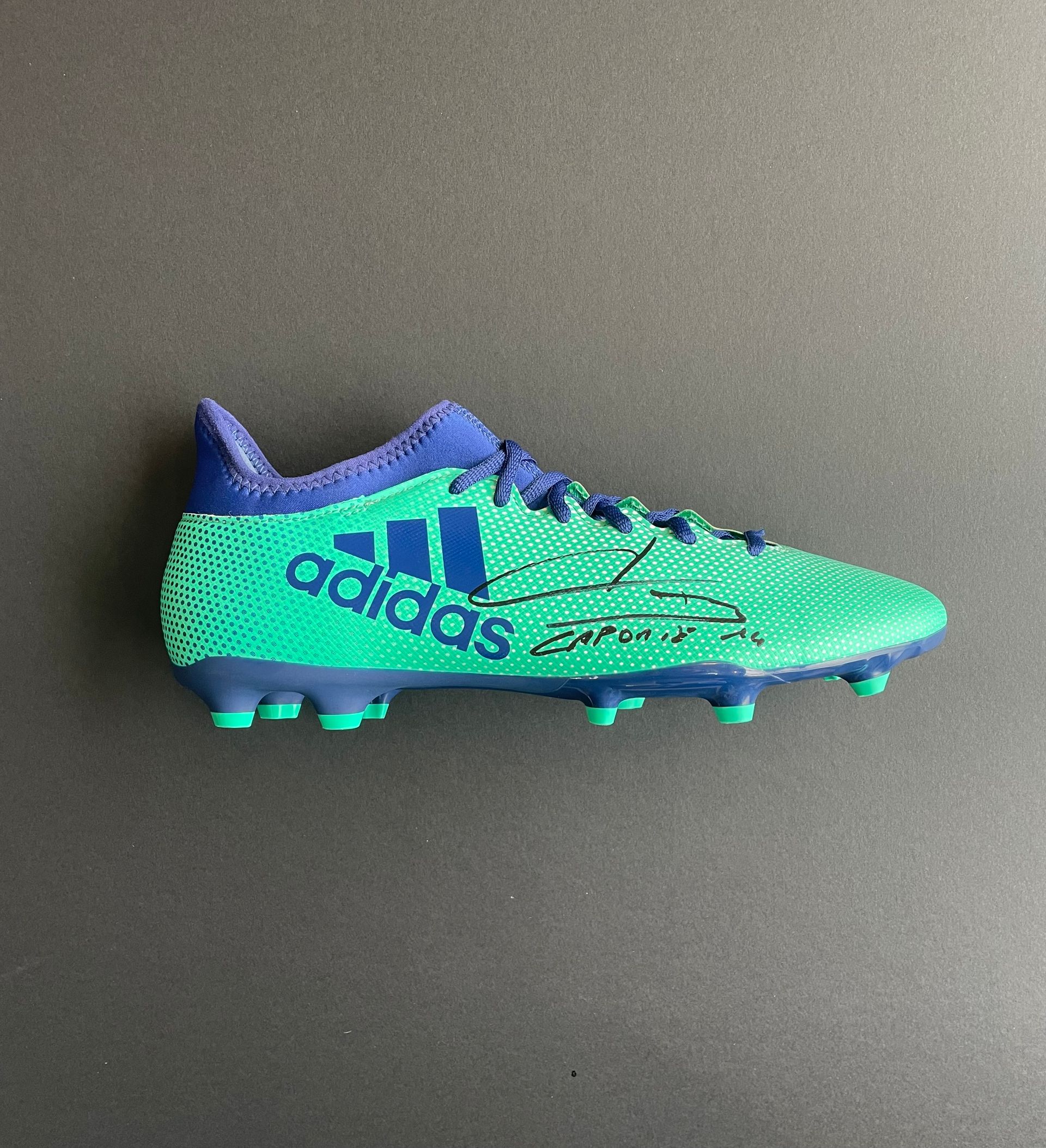 Aymeric Laporte signed boot. Blue and green Adidas soccer cleat shown in side view on a dark background